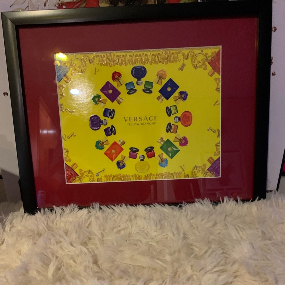 Framed Versace perfume box.